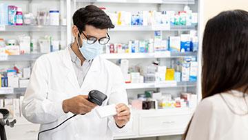 Pharmacist scanning a prescription.